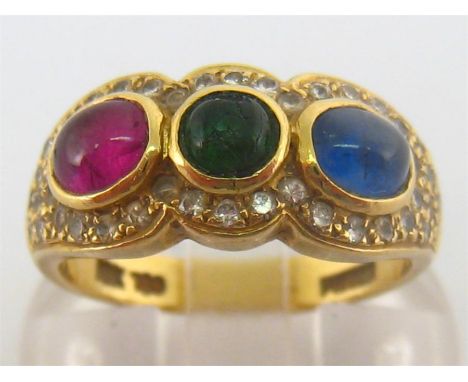 A ruby, sapphire, emerald and diamond ring, the three cabochon stones collet set in a surround of pave set brilliants, the sh