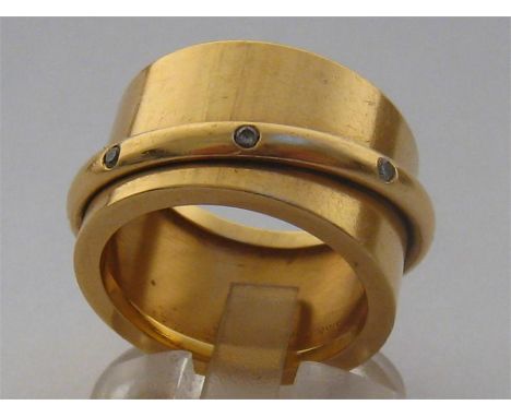 An 18 carat gold and diamond band by Dinh Van, the wide shank with an overlaid diamond set band, signed and stamped ‘750’ to 