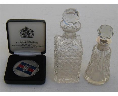 A silver mounted cut glass scent bottle, Birmingham 1946, together with another unmounted cut glass bottle, and a white metal
