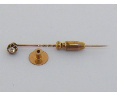 A late Victorian gold and diamond stick pin, the old cut approx 0.2 carat, together with gilt metal securing toggle and gold 