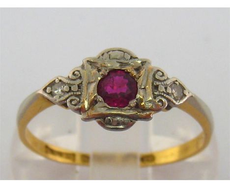 An Art Deco 18 carat gold, platinum, diamond and ruby ring, the central round cut stone 3.2mm diameter within a chased platin