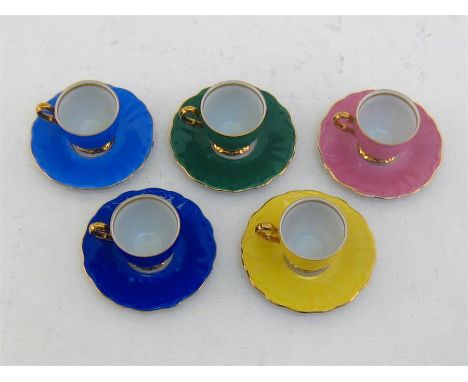A set of five porcelain Rosenthal coffee cups and saucers, each in a different colour, yellow, pale and dark blue,  green and