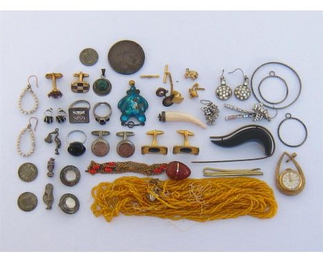 A mixed lot of silver and costume jewellery, including a pair of silver cuff links, three silver charms, an enamel pendant, a