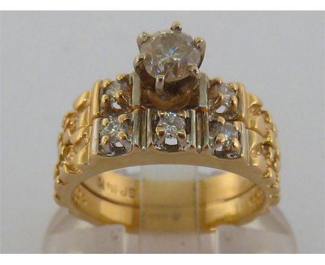 A yellow gold and diamond ring, designed in two bands, the upper band with pronounced claw set brilliant approx. 0.39 carat, 