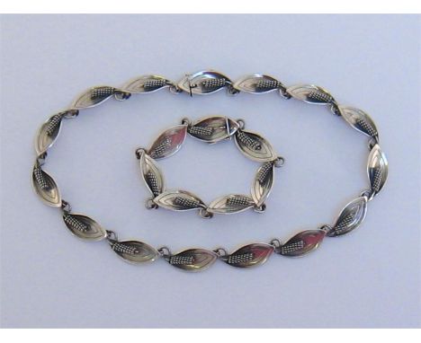 A Modernist Danish silver necklace and bracelet by Aarre & Krogh (1949-1990), composed of stylised leaves and stamen, to a co