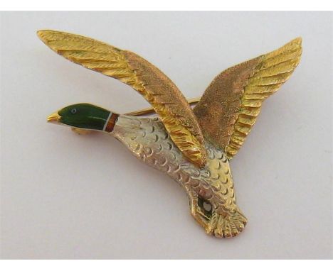 A 1970s 9 carat three colour gold and enamel brooch by Tarratt, Birmingham 1973, designed as a mallard in flight, 4cm long, 7