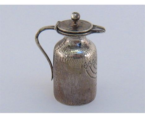 Judaica. A German, silver oil bottle for filling the Chanukah lamp, 1930s, with strap  handle, spout and lid, the finely plan