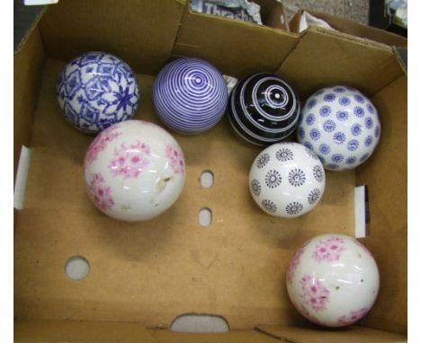 A collection of seven decorated ceramic spheres : 