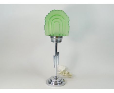 CHROME TABLE LAMP. A chromed table lamp with green glass shade. Height 48cm. Note: Some of these lamps may have modern but pe