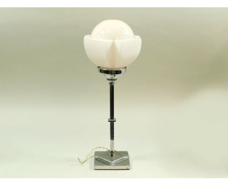 CHROME TABLE LAMP. A chromed table lamp with pink glass shade. Height 46cm. Note: Some of these lamps may have modern but per