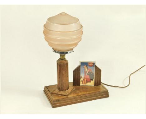 OAK LAMP & PHOTO FRAME. An oak combined table lamp with pink glass shade & photograph frame. Height 50cm, base 18 x 33cm.Cond