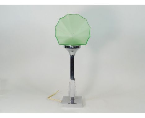 CHROME TABLE LAMP. A chromed table lamp with green glass shade. Height 45cm. Note: Some of these lamps may have modern but pe