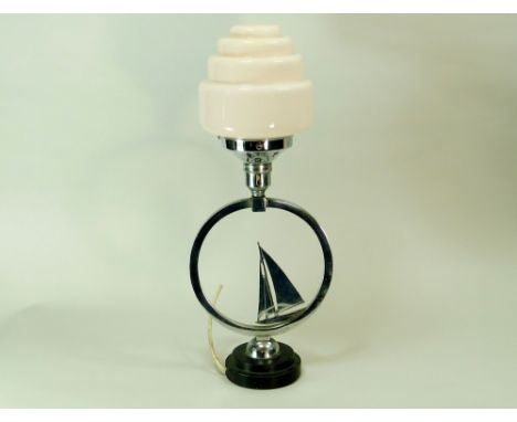 CHROME TABLE LAMP. A chromed yacht design table lamp with light pink glass shade. Ebonised base. Height 45cm. Note: Some of t