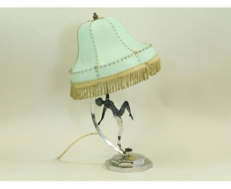 CHROME TABLE LAMP. A chromed figure table lamp with fringed green shade. Push button switch. Height 43cm. Condition:Good cond