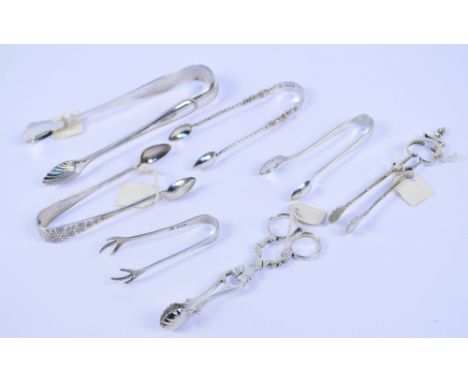 A collection of hallmarked silver tongs comprising a Victorian pair with shell bowls, James Wright, Edinburgh 1864, a pair wi