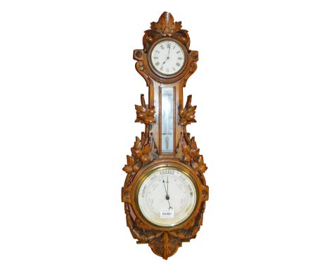 A 20th century Black Forest oak barometer/thermometer/clock carved with leaves and husk garlands, height 69 cm.