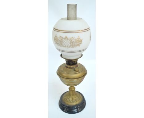 A Victorian oil lamp with brass reservoir on spreading circular ornamental foot with turned base, with white opaque globular 