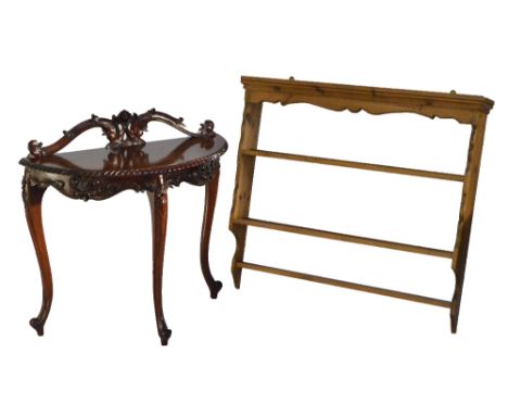 A reproduction mahogany bowfronted hall table with carved scroll back, on three cabriole legs with scrolling feet, width 89cm