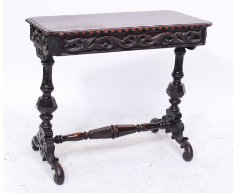 A Victorian caved oak centre table decorated with foliate scrolls to sides and stretchered ring turned supports, 84 x 42cm, h