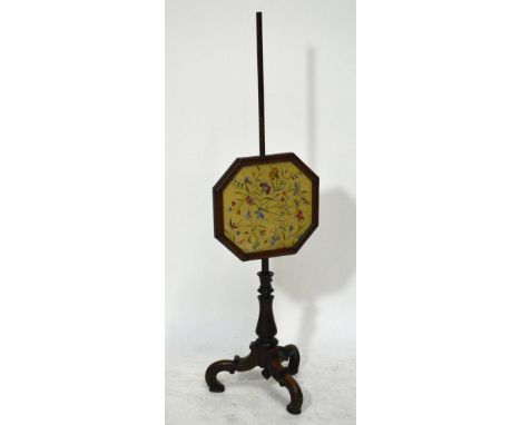 A 19th century rosewood pole screen with octagonal glazed silk floral tapestry, on ring turned baluster column on three S-scr