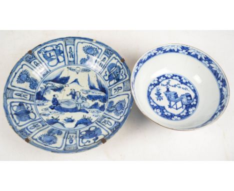 An early 18th century Chinese circular shallow bowl painted in underglaze blue with figural garden scene within decorative bo
