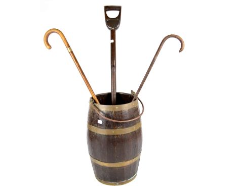An early 20th century brassbound coopered oak barrel, with swing loop handle, an unusual spade bearing presentation plaque in
