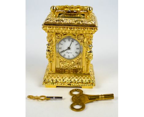 A small gilt metal carriage clock with overall ornamental and figural decoration, the circular enamel dial set with Roman num