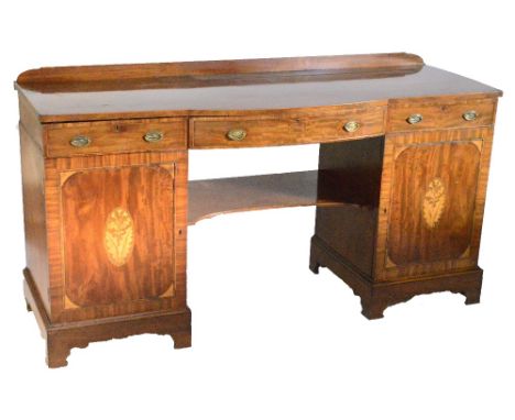 A large Edwardian figured mahogany sideboard with low shaped gallery, central bay section, crossbanded with string inlay abov