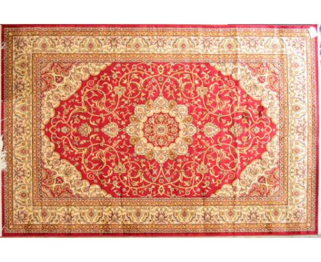 A red ground Keshan carpet with large central motif within a floral set border, 230 x 160cm.