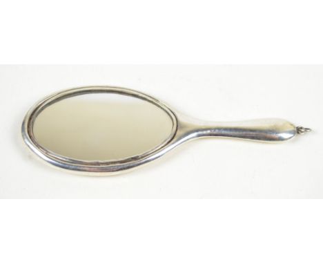 HENRY MATTHEWS; an Edward VII hallmarked silver backed miniature hand mirror, with suspension ring, Birmingham 1909, length 1