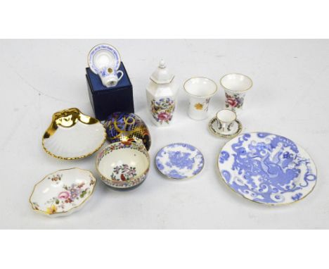 A group of Royal Worcester ceramics to include two miniature cups and saucers, one commemorating "A First Child to The Royal 