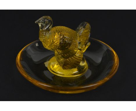 LALIQUE; an amber glass pin dish with central figure of turkey, with cut signature "R. Lalique France" to base, height 7cm, d