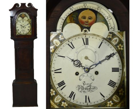 An early 19th century mahogany longcase clock, the hood with broken swan neck pediment above arched painted dial above rollin