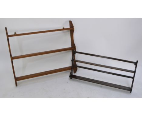 An Ercol dark elm plate rack, length 96cm, and a pitch pine example, length 100cm.
