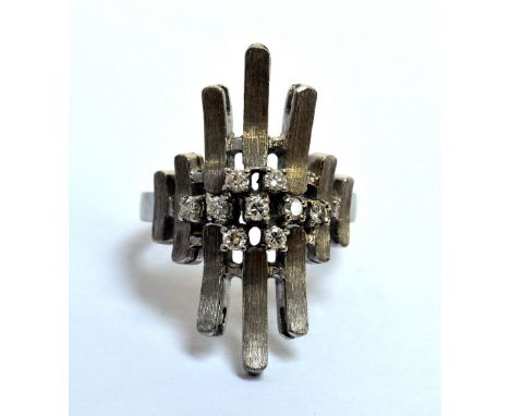 An 18ct white gold and diamond set ring of abstract form, size Q.