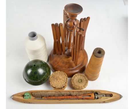 A vintage turned wooden wool winder with concertina arms, on circular base, a shuttle, a turned wood cop bobbin, a spherical 