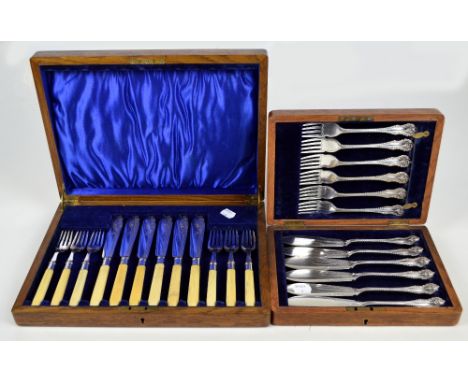 A cased set of six fish knives and forks with hallmarked silver collars and ivorine handles and a further cased set of six el