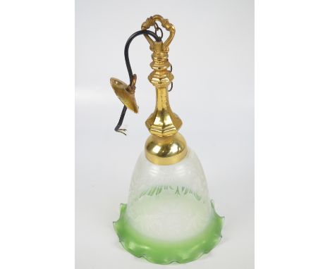 A brass ceiling lamp with octagonal baluster body and floral etched and green tinted bell shaped shade, total height 44cm.