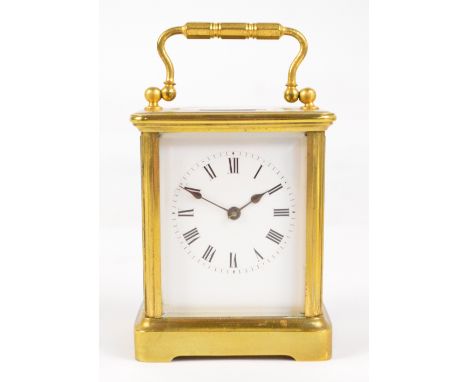 A late 19th century French brass cased carriage clock, with swing loop handle above rare anchor escapement, rectangular white