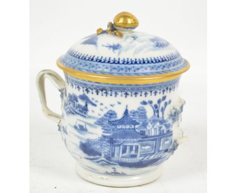 An early 20th century Chinese porcelain twin handled cup of baluster form painted in underglaze blue with continuous architec