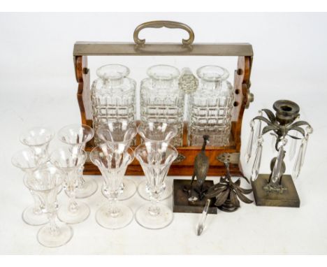 A small group of glass comprising a set of four wine glasses, a set of five matching smaller examples, an oak tantalus housin