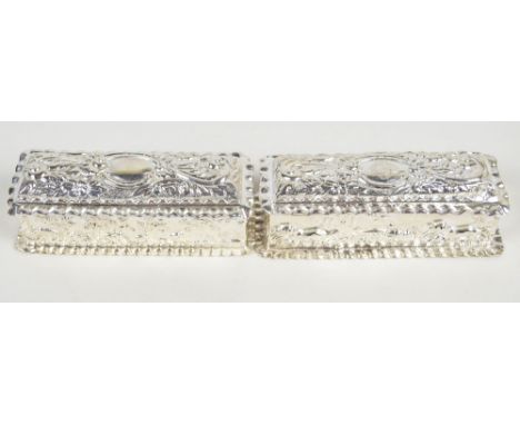 THOMAS HAYES; a pair of Victorian hallmarked silver rectangular trinket boxes one embossed with hounds chasing birds, initial