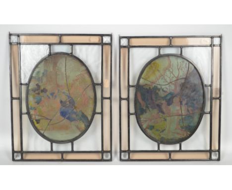 A pair of rectangular leaded glass panels with painted oval central sections depicting the Adoration of the Shepherds and St 
