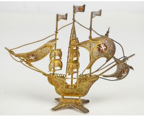A Portuguese silver gilt filigree work model of galleon with three enamelled Order of Christ cross emblems to the masts, Opor
