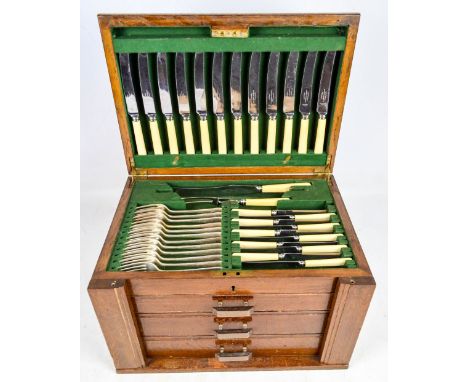 HARRISON, FISHER & CO, SHEFFIELD; an oak cased canteen of electroplated cutlery with three drawers. CONDITION REPORT: 12 Dinn