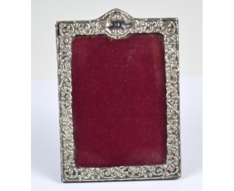 HENRY MATTHEWS; a Victorian hallmarked silver fronted rectangular photograph frame overall embossed with foliate scrolls, cen