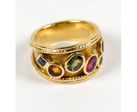 A 14ct yellow gold dress ring set with six various faceted gem stones of various sizes, colours and shapes, size Q, approx 9.