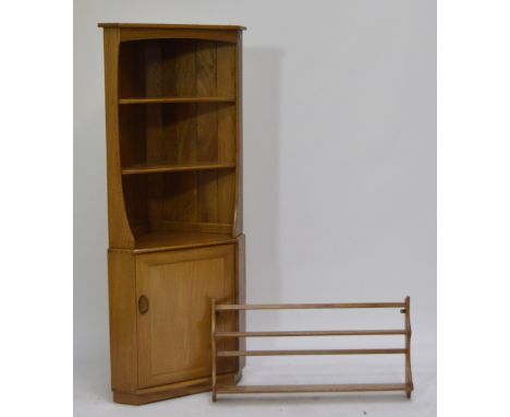 An Ercol freestanding corner cupboard with three open shelves above single cupboard door, height 177cm and a wall mounted pla