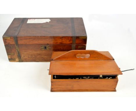 A Victorian walnut brassbound writing slope for restoration and a two division cutlery box containing cutlery and a clarinet.