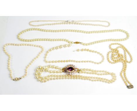 Five various simulated pearl bead necklaces to include a three strand graduated example with large decorative yellow metal cl